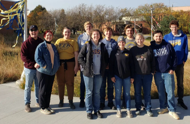 Botany Club poses for a picture at the AISC where they just completed a native plant planting.