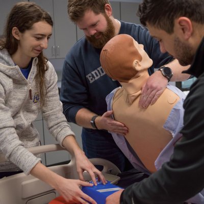 nursing students working with dummy