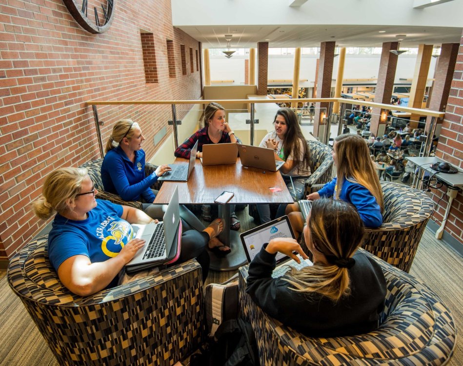 Students studying around table in union
