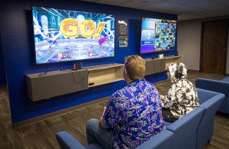 Students gaming on big-screen TVs in the Jacks Esports Lounge.