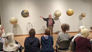 Dick Termes discusses Termespheres with South Dakota Art Museum docents.