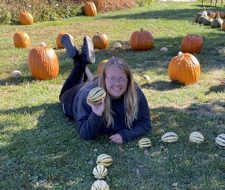 Alexis Barnes posing with pumpkins 