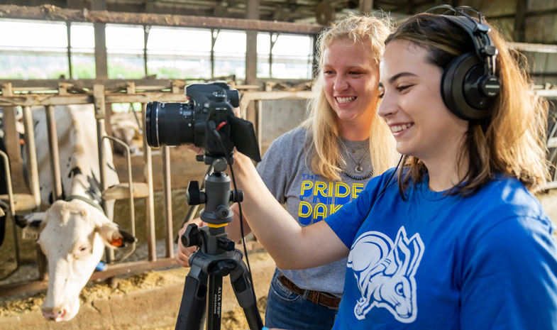students with a camera at a dairy