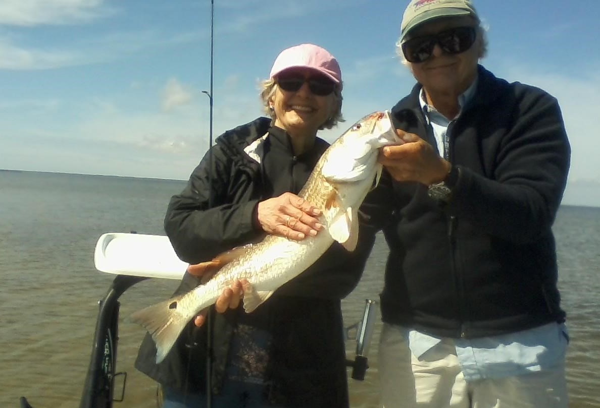 Michele's fishing a big red fish in Florida