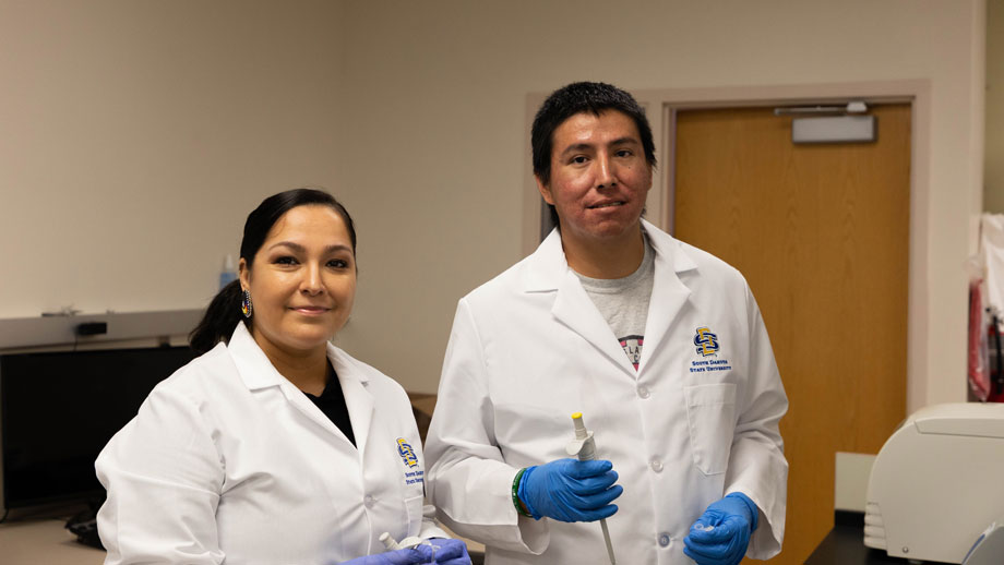 Oglala Lakota College students Candy DuBray, left, and Charles Bush prepare to do DNA extractions in Nepal’s lab 