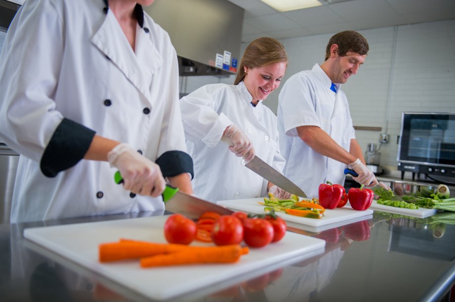 Dietetic students cutting vegetables