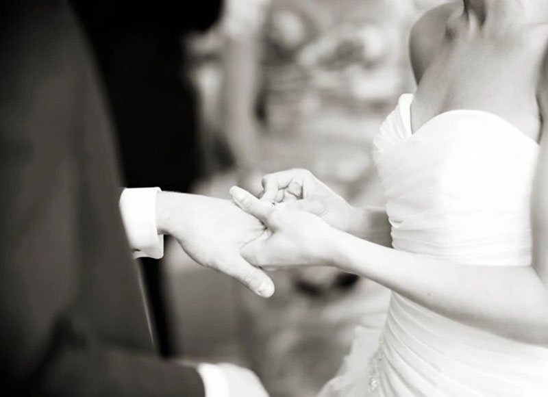 bride slips ring on groom