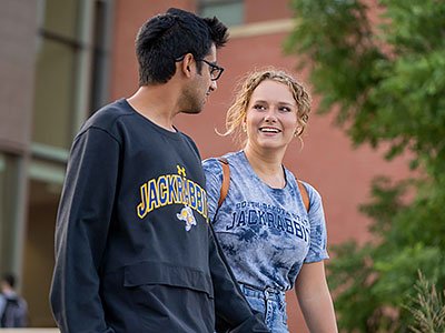 Two student walking on campus