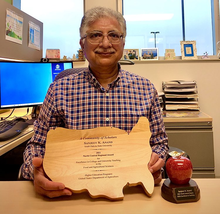 Sanjeev Anand receives an award for teaching excellence from the USDA
