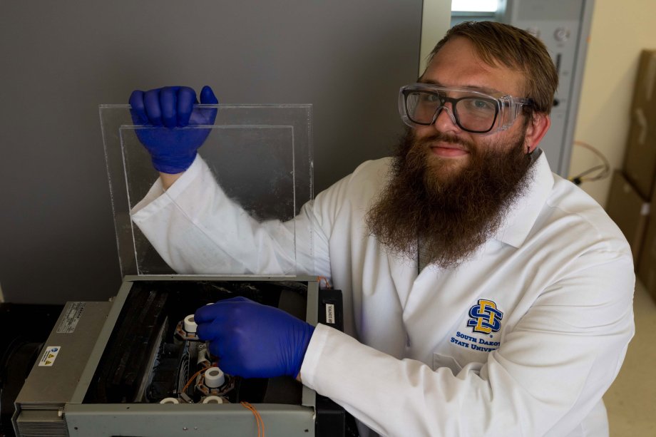 Doctoral student Kyle Burch with analytical chemistry instrument