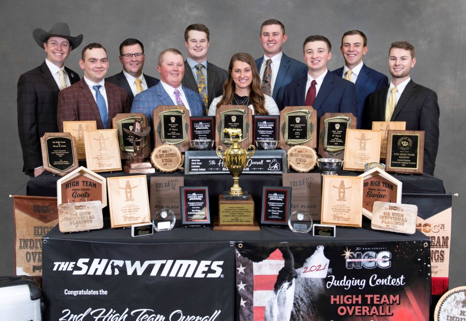 Livestock Judging Team members lined up behind their array of earned banners, plaques and trophies they won in 2021.