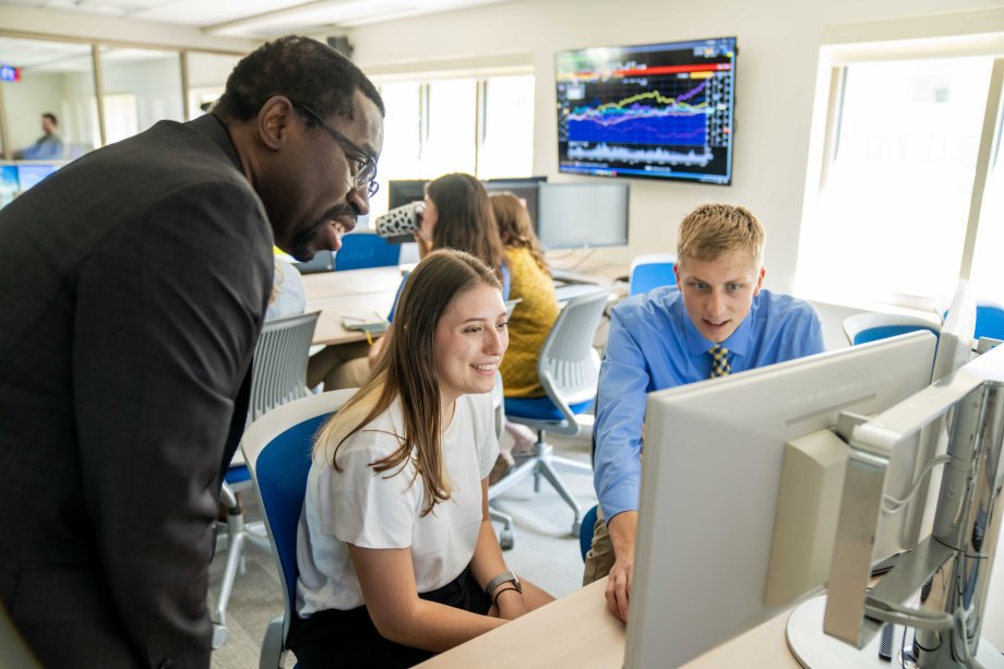 Ujah with students in trading lab