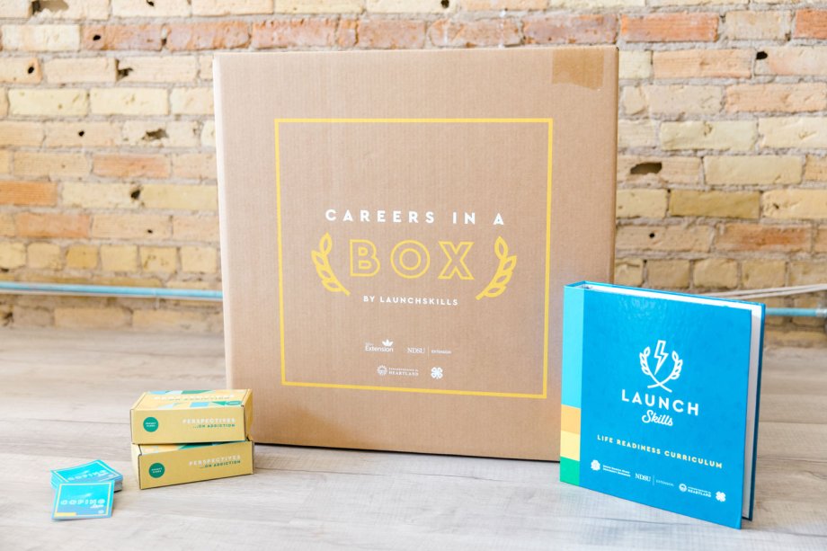 Careers in a Box and Launchskills Binder in front of a brick wall