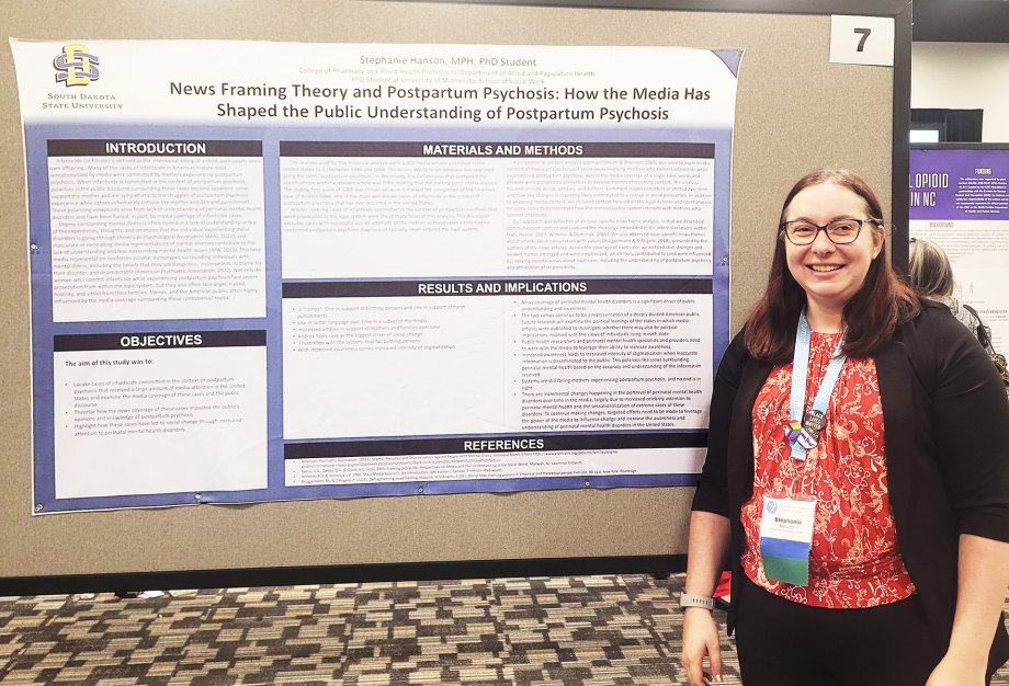 Stephanie Hanson stands next to her poster at the Postpartum Support International annual conference.
