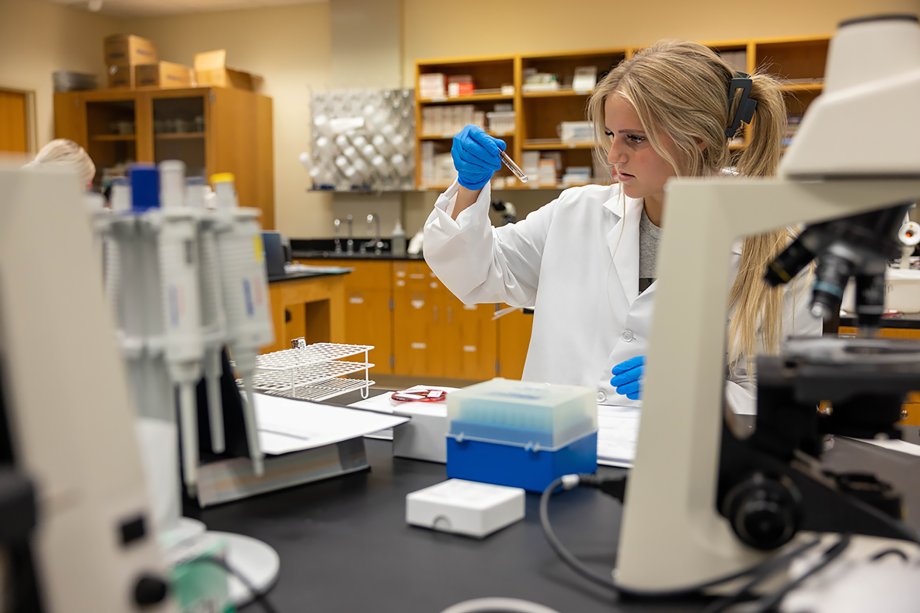An SDSU phlebotomy students works in a lab on campus.
