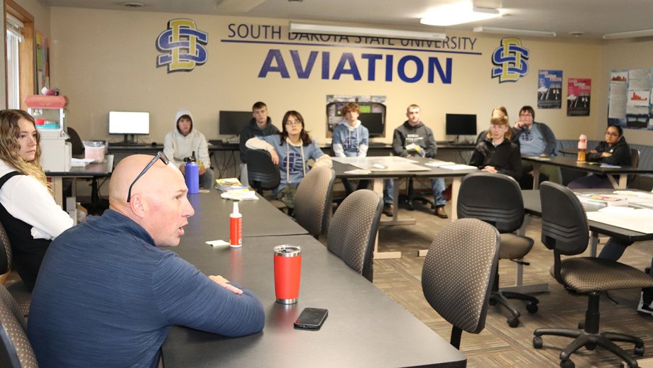 SDSU Director of Aviation Operations Devin Bastemeyer speaks to Career and Technical Education Academy students from Sioux Falls during a site visit at the Brookings Regional Airport in October.