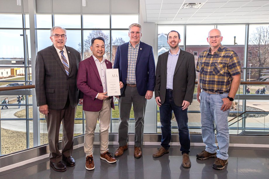 South Dakota State University and EAPC representatives pose with the Merit Award in Architecture from the South Dakota chapter of the American Institute of Architects, awarded for EAPC's design of the Raven Precision Agriculture Center.