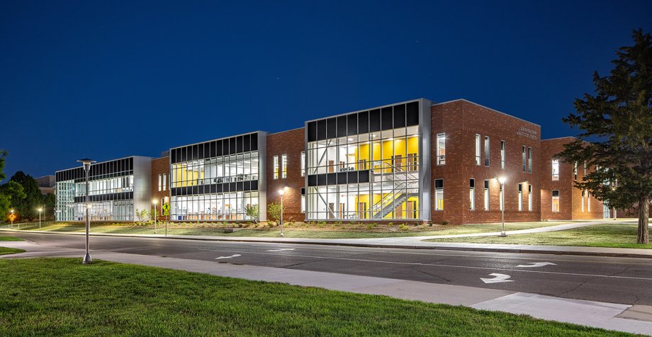Exterior, nighttime photo of the Raven Precision Agriculture Center.