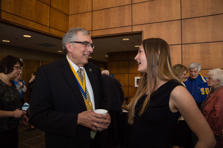 Barry H. Dunn visits with Allyson Helms, SDSU Student Association President after the announcement
