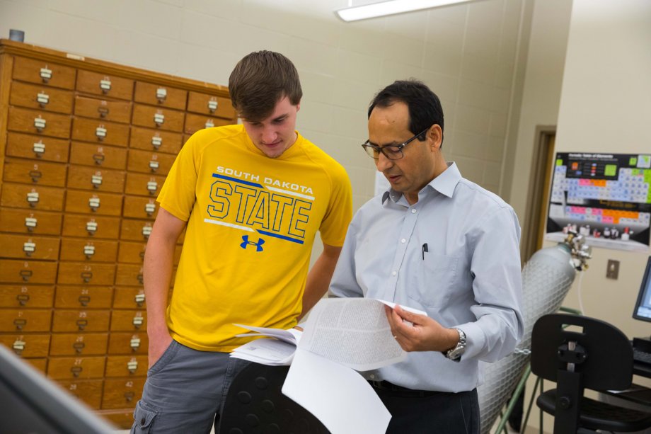 Kyle discussing research with Dr. Kharel