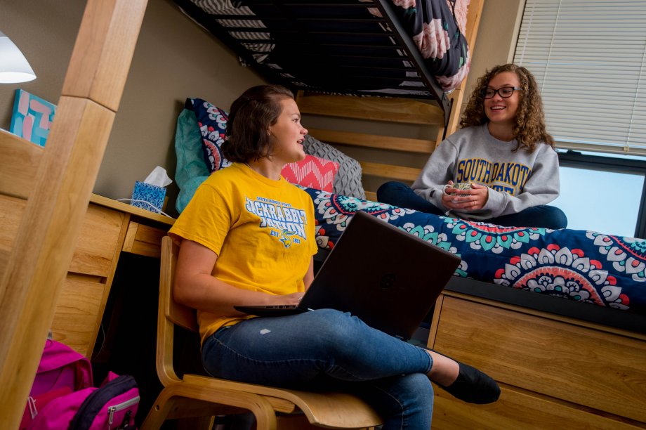 Students sitting in a residence hall room