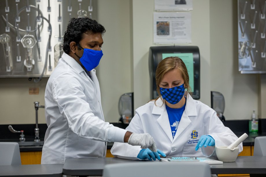 Researcher working with student in lab