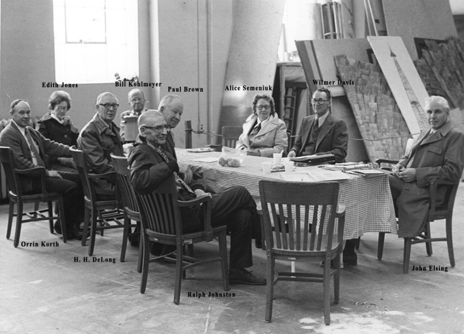 "Image of advisory committee seated around table. Seven men and two women."