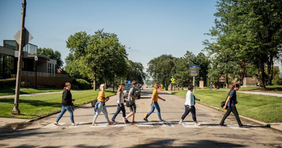 Students walk across the crosswalk