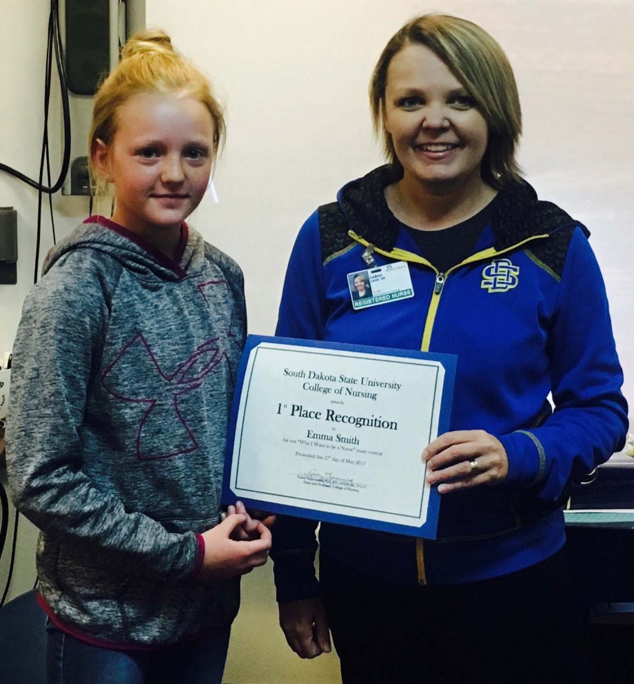 Emma Smith, a fifth-grader at Hermosa Elementary School, receives a certificate from LeAnn Lamb, an instructor with the West River Nursing Department. Smith was winner of South Dakota State University's 16th annual "Why I Want to be a Nurse" essay contest.