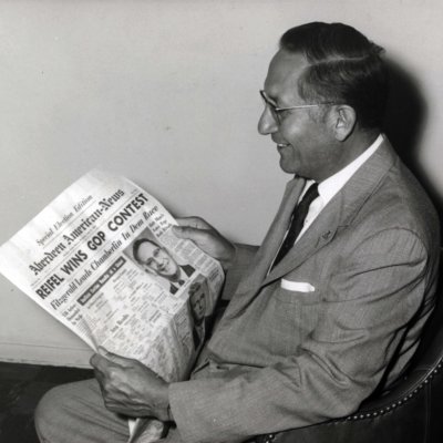 Reifel reads headline announcing his win in the primary