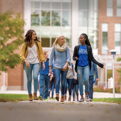 Three female students walking together on campus
