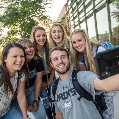 Students taking a selfie outdoors