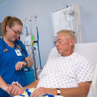 Nursing student working with a patient.