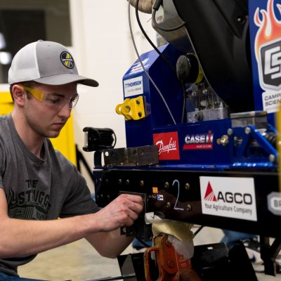A student with the Quater Scale Tractor team works on a prototype.