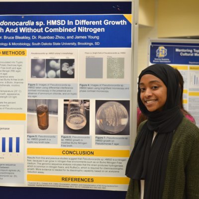 Student presenting her research with the poster