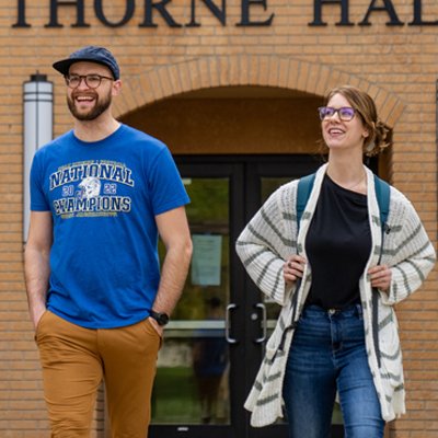 Two students walking outside of Thorne Hall