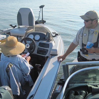 Natural Resource Law Enforcement on a bat checking another boat