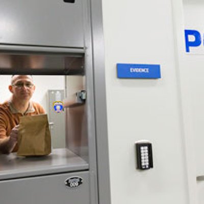 A man standing with a bag at an evidence locker.