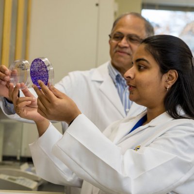 Gunaje and Sankaranarayanan examining cell cultures