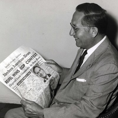 Ben Reifel reading a headline about his 1960 primary victory.