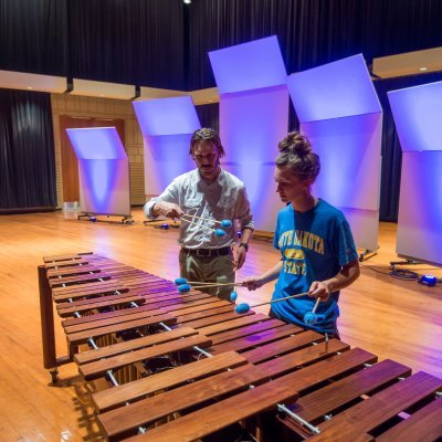 Instructor giving marimba lesson to student