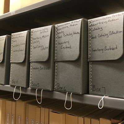A shelf showing archival boxes