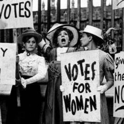 women holding signs that say votes for women