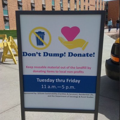A promotional sign for Don't Dump! Donate!