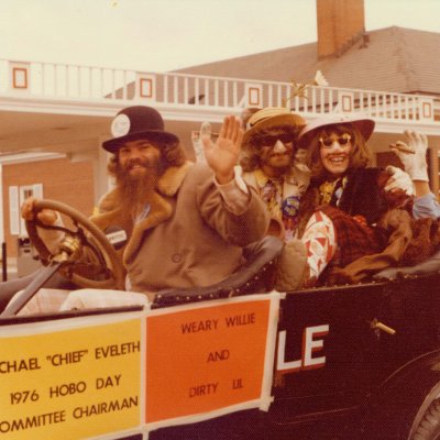 Michael Eveleth with Weary Willie and Dirty Lil riding in the Bummobile during the 1976 Hobo Day Parade.
