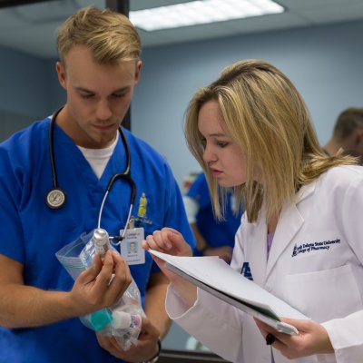 Pharmacy and nursing student working together