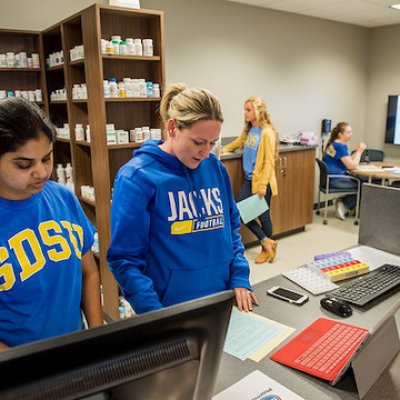 Pharmacy students learning in simulation facility
