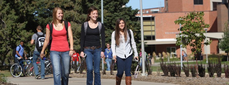 Students walking on sidewalk by union