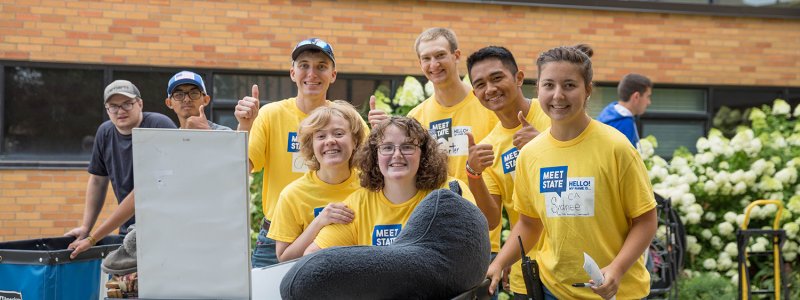 Meet State volunteers posing for picture while helping move new students in.