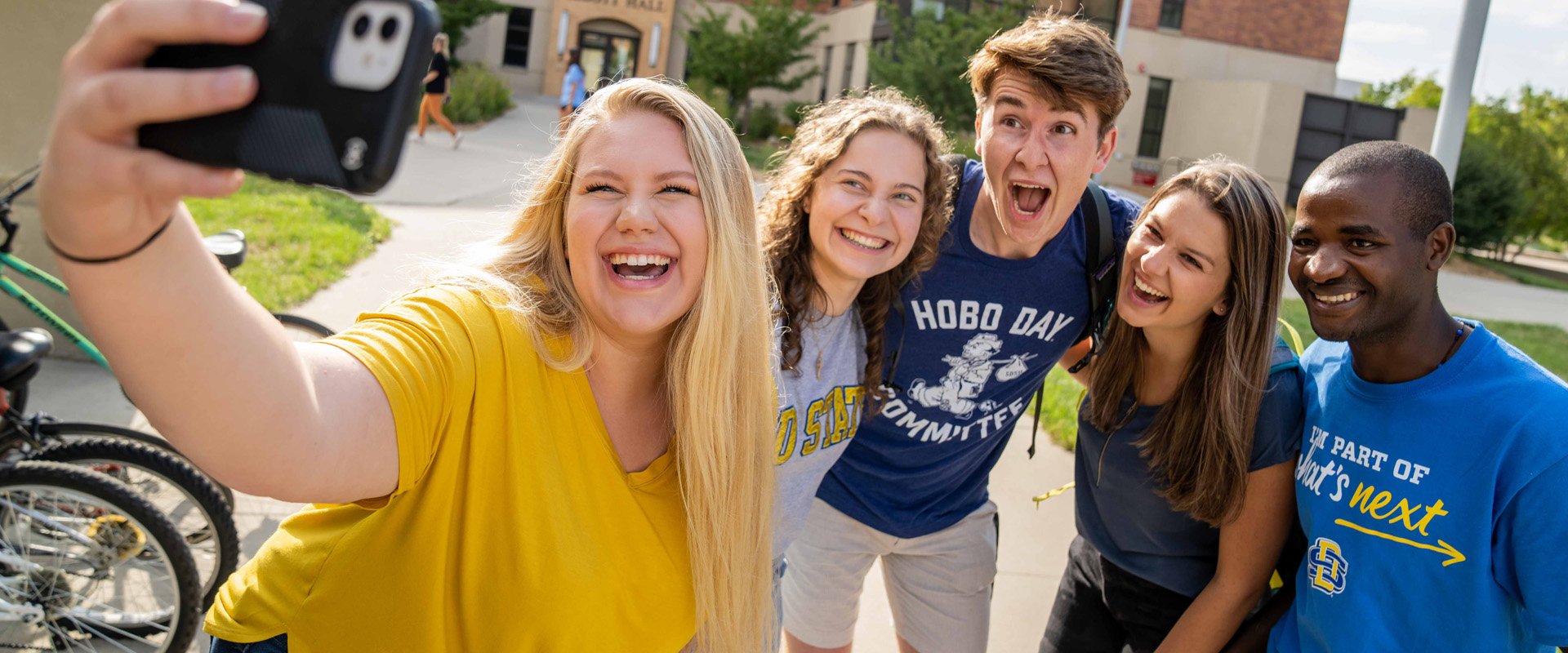 Five SDSU students standing outside taking a selfie